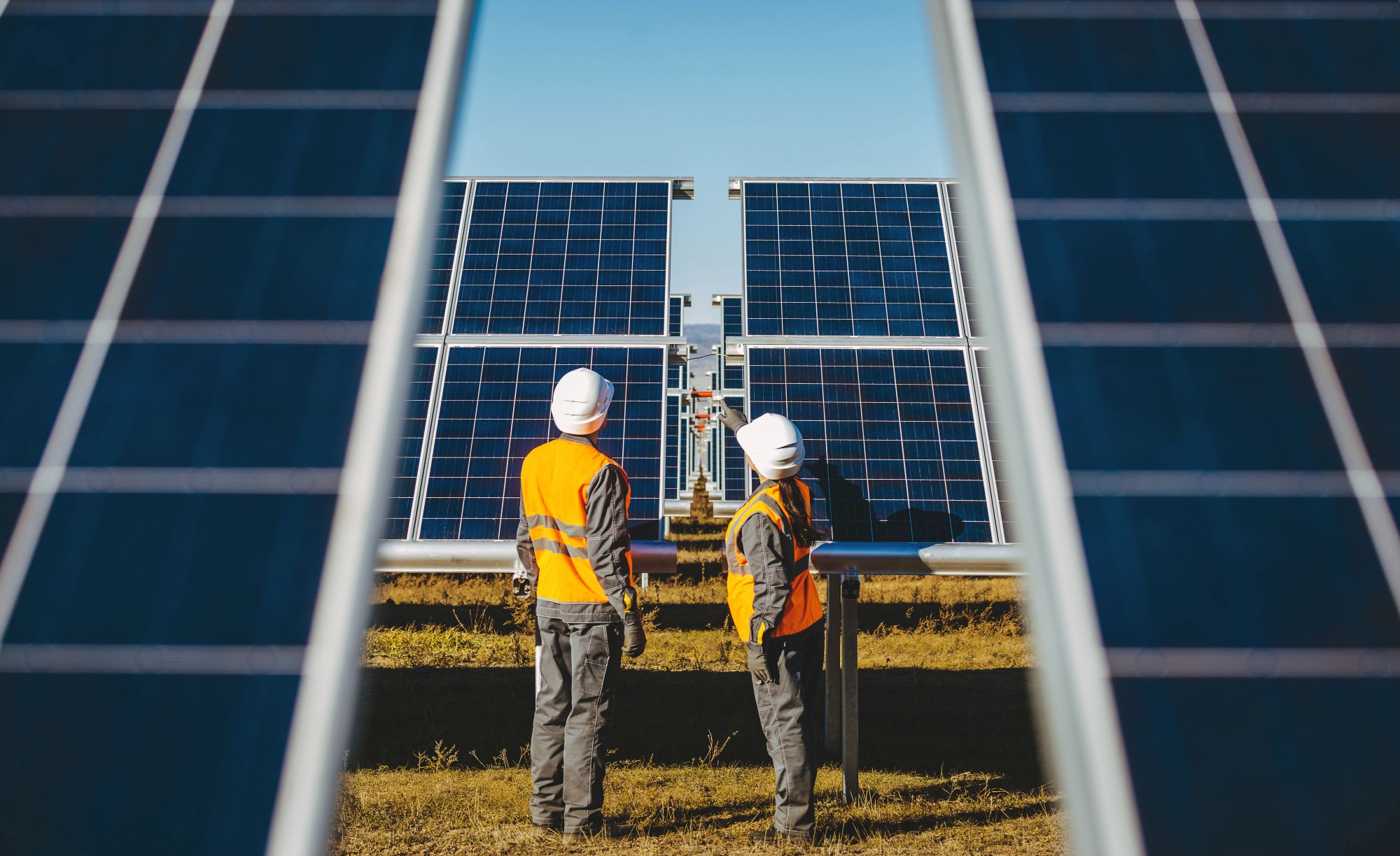 two workers at solar panel station